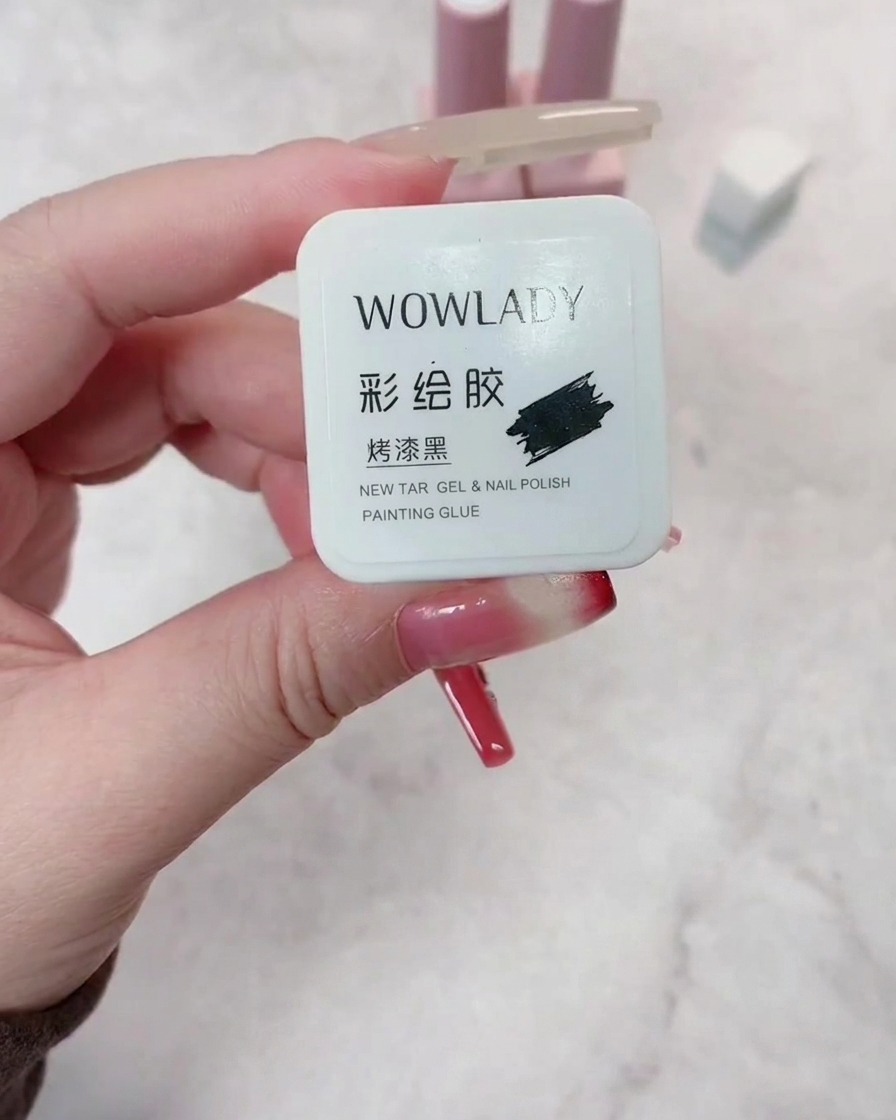 A brush applying dark red gel polish onto a prepped nail, ensuring even coverage.
