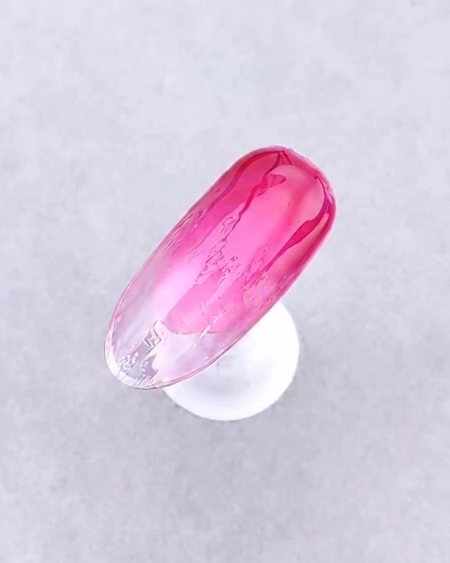 A close-up view of the finished gradient nail look after curing under the lamp.