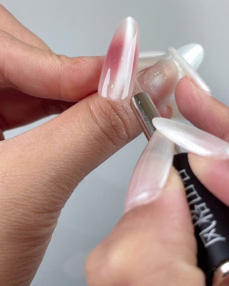 A detail magnetic tool tip refining the cat-eye particles near the cuticle area of a nail.