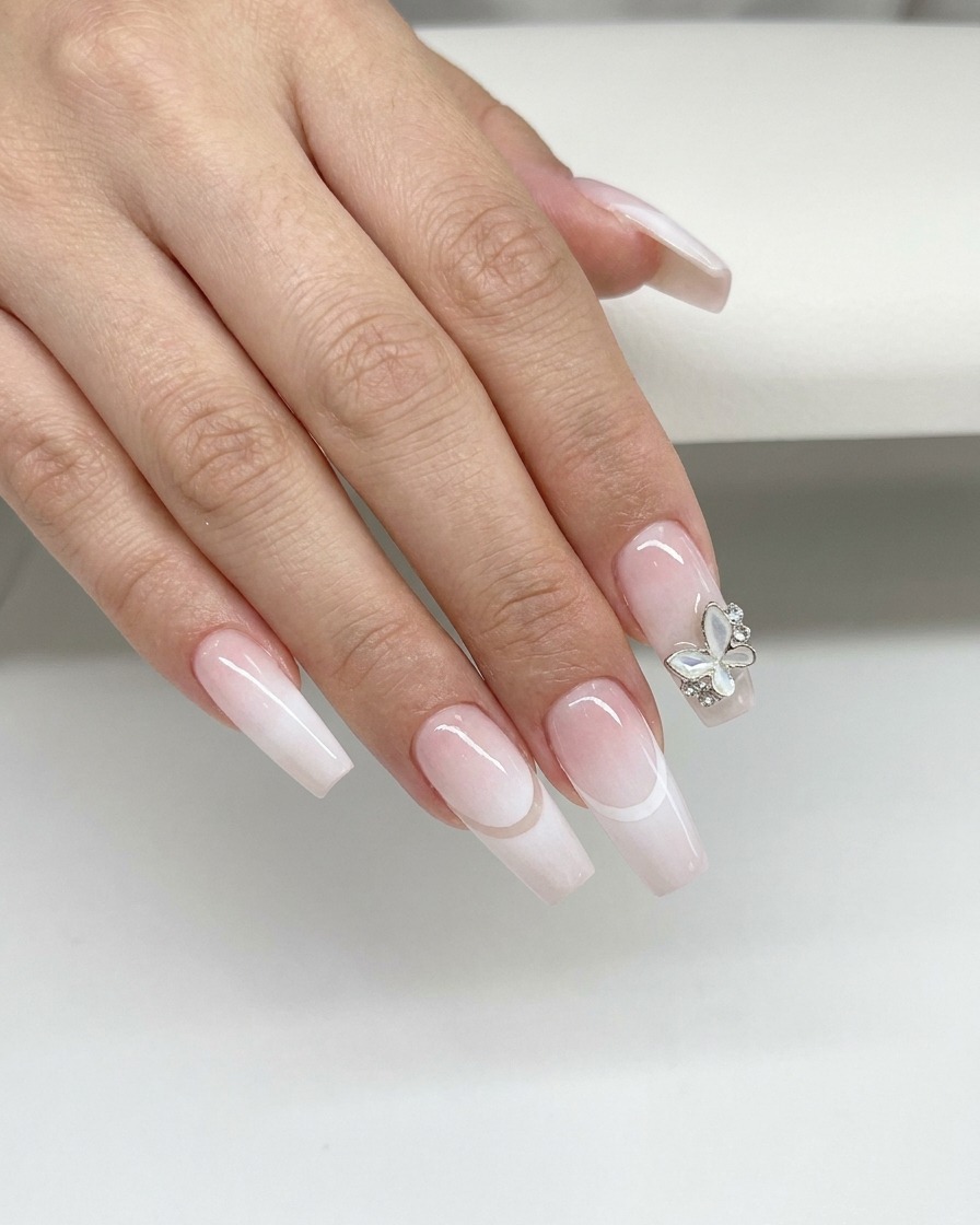 A blue silicone makeup tool wiping along the curved smile line of a nail to clean up excess white gel.