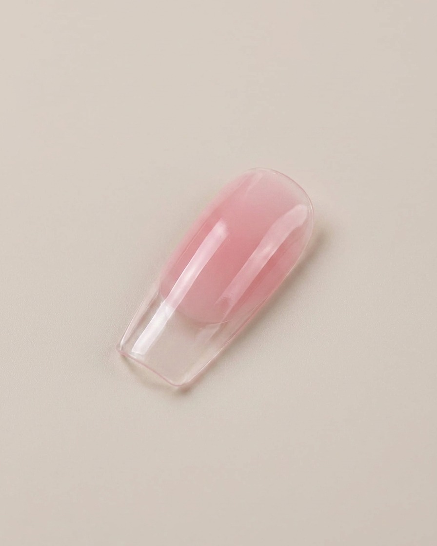 A close-up of a glossy translucent pink artificial nail display tip.