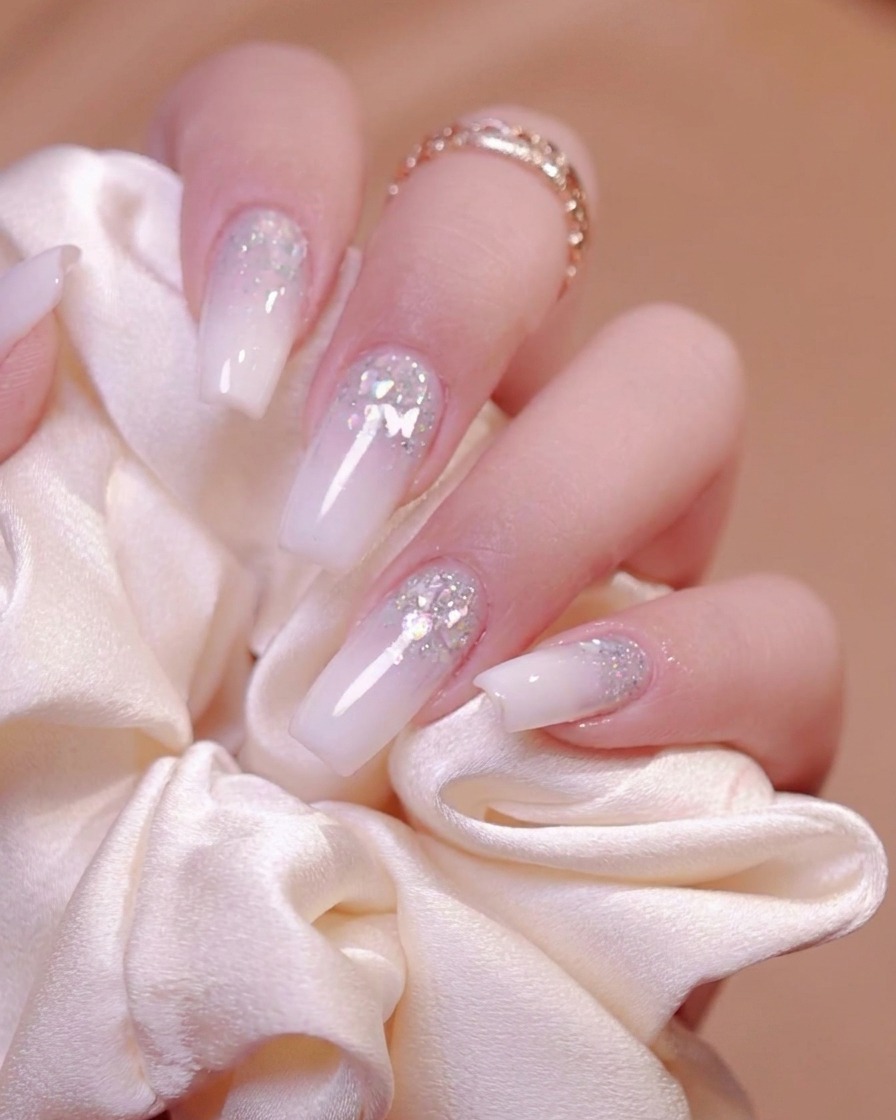 A lint-free wipe cleaning the sticky residue off cured nails.