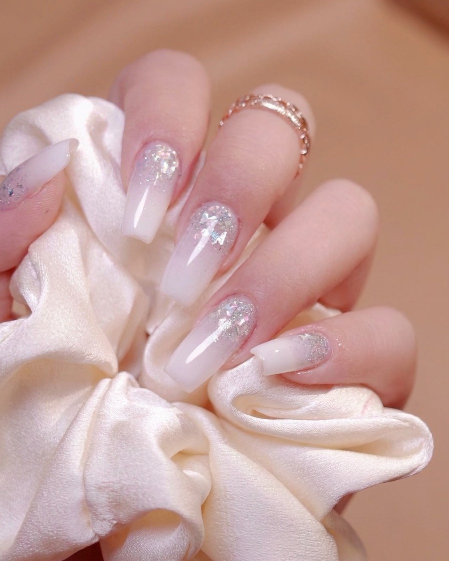 Detailed filing around the nail edges to create a smooth and natural nail arc.