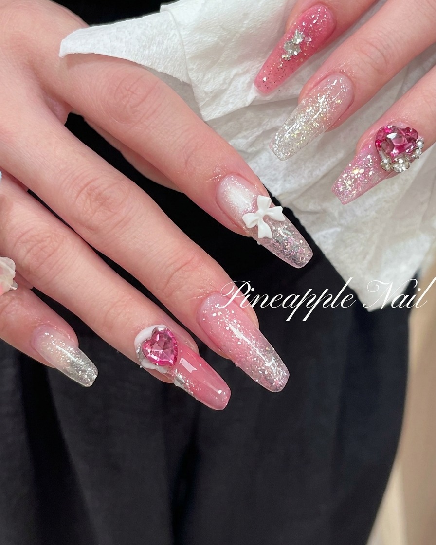 Hands positioned to show the side profile and structure of long almond-shaped nail extensions.
