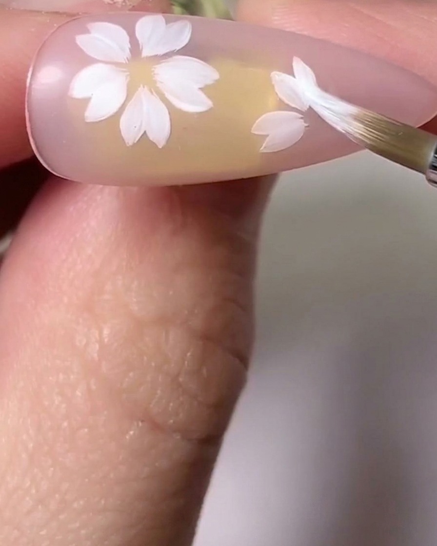 A brush blending pink and white shades on cherry blossom petals to add depth.