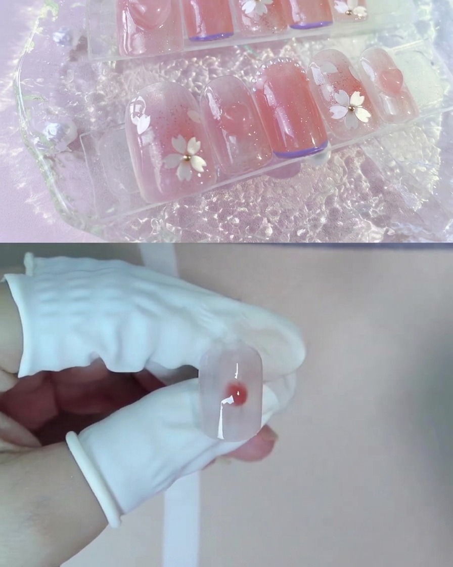 A drop of darker nude peach gel resting in the center of wet blooming gel on a nail.