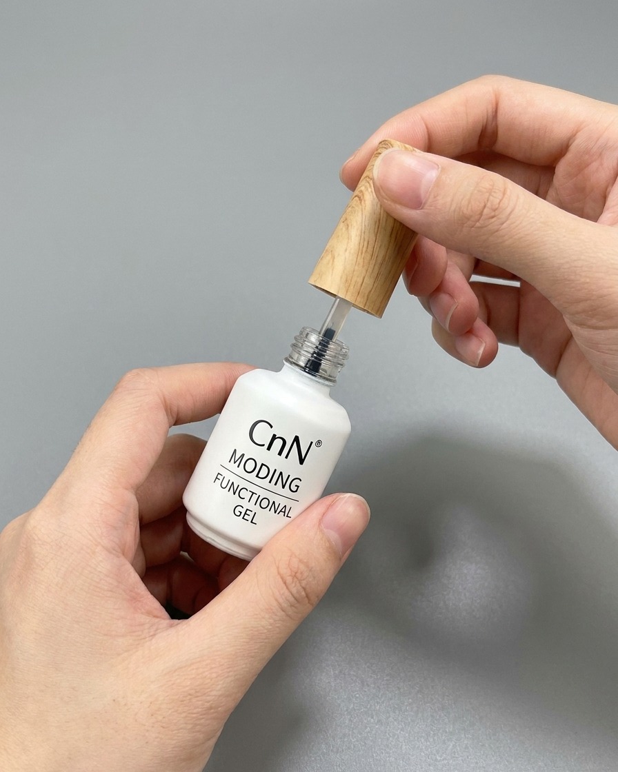 A bottle of functional top coat gel with its brush being pulled out.