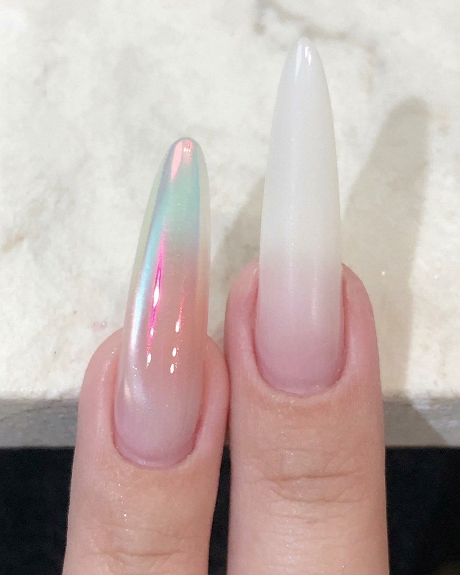 A pointed brush applying pink blush gel directly onto the center of the nail.