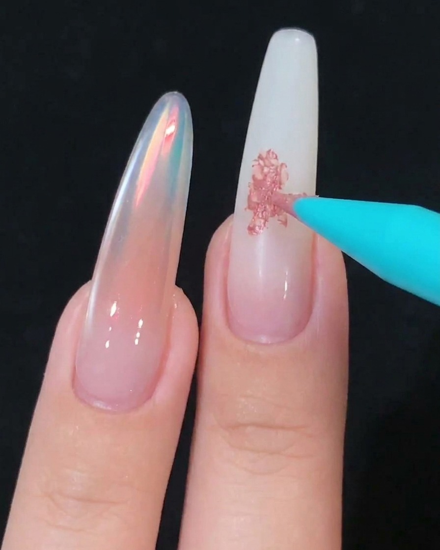 A foam sponge tool gently blending pink gel on the nail surface.
