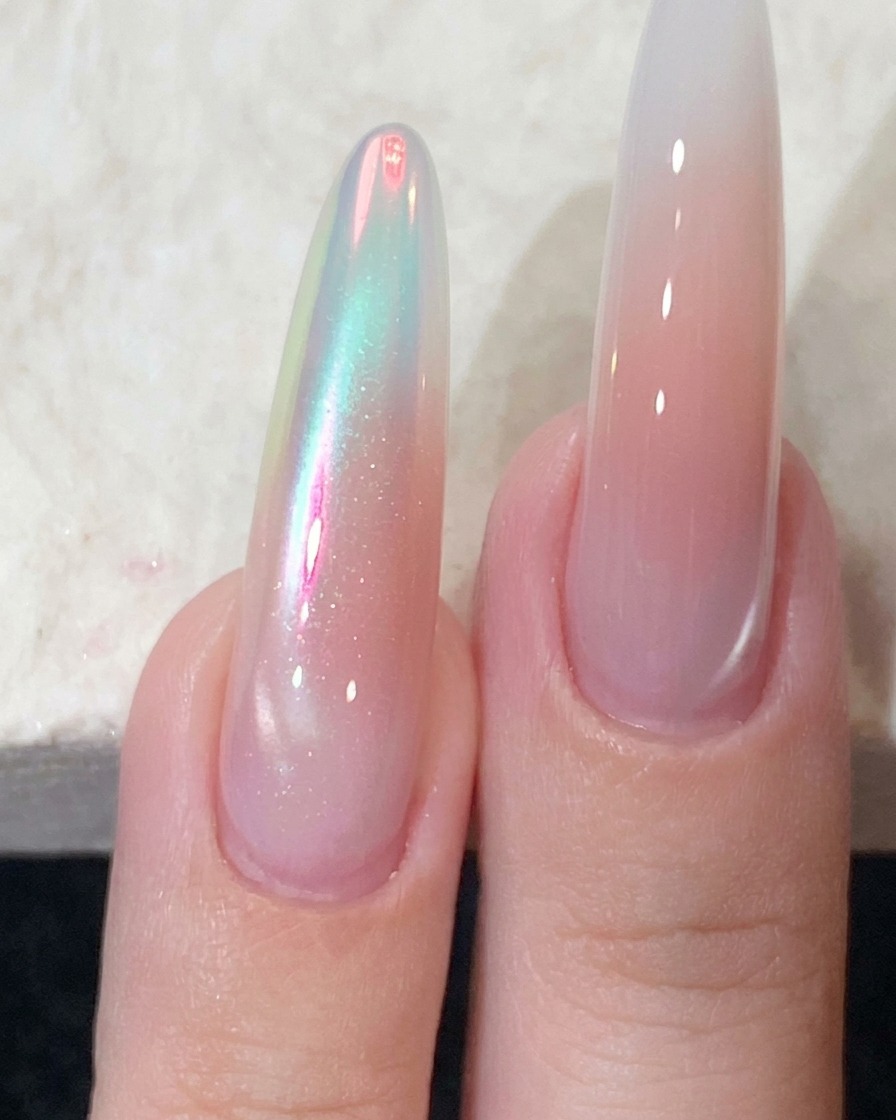 A strong magnet held close to the side of a manicured nail to shape the magnetic shimmer.