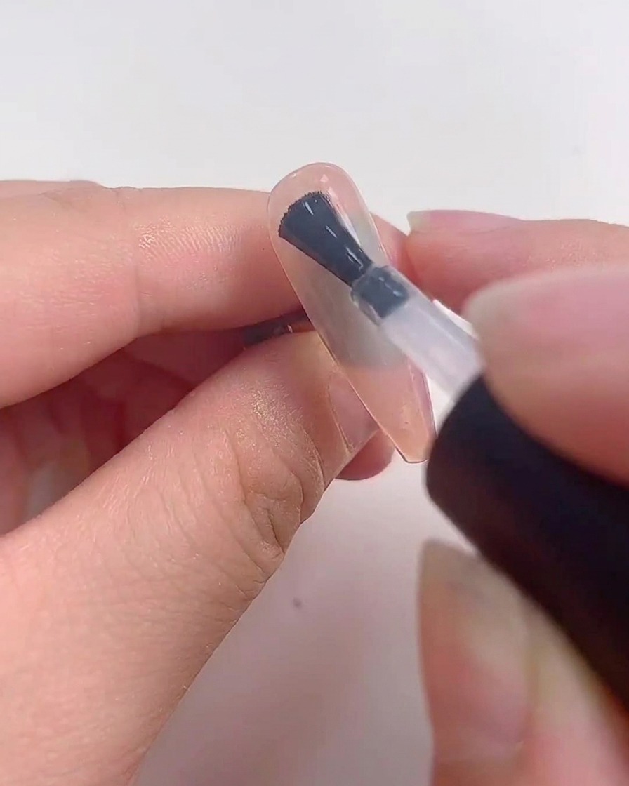 A nail placed under a UV or LED lamp during the curing process.