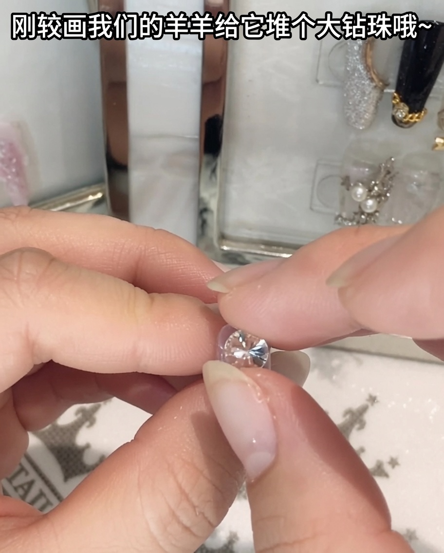 A pair of tweezers holding and positioning a large crystal rhinestone.
