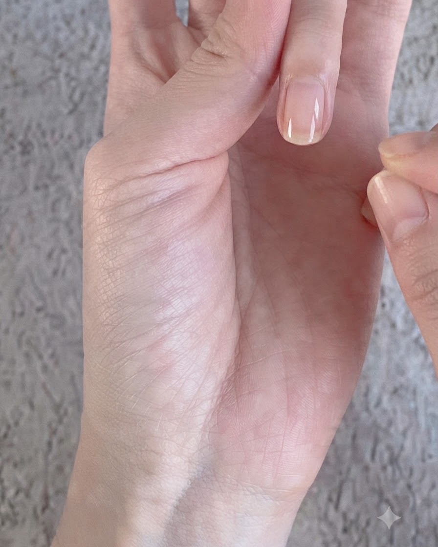 A sponge eyeshadow applicator rubbing silver magic mirror chrome powder onto a smooth glossy nail surface.
