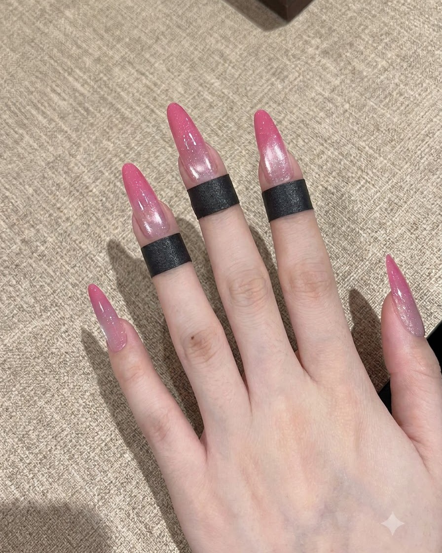 A nail brush applying a clear base coat onto a prepped fingernail.