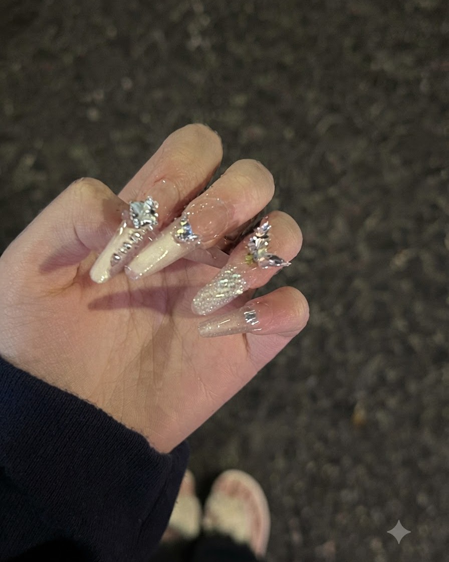 A hand pose adjustment showcasing light reflection and glossy finish on rhinestone-decorated nails.