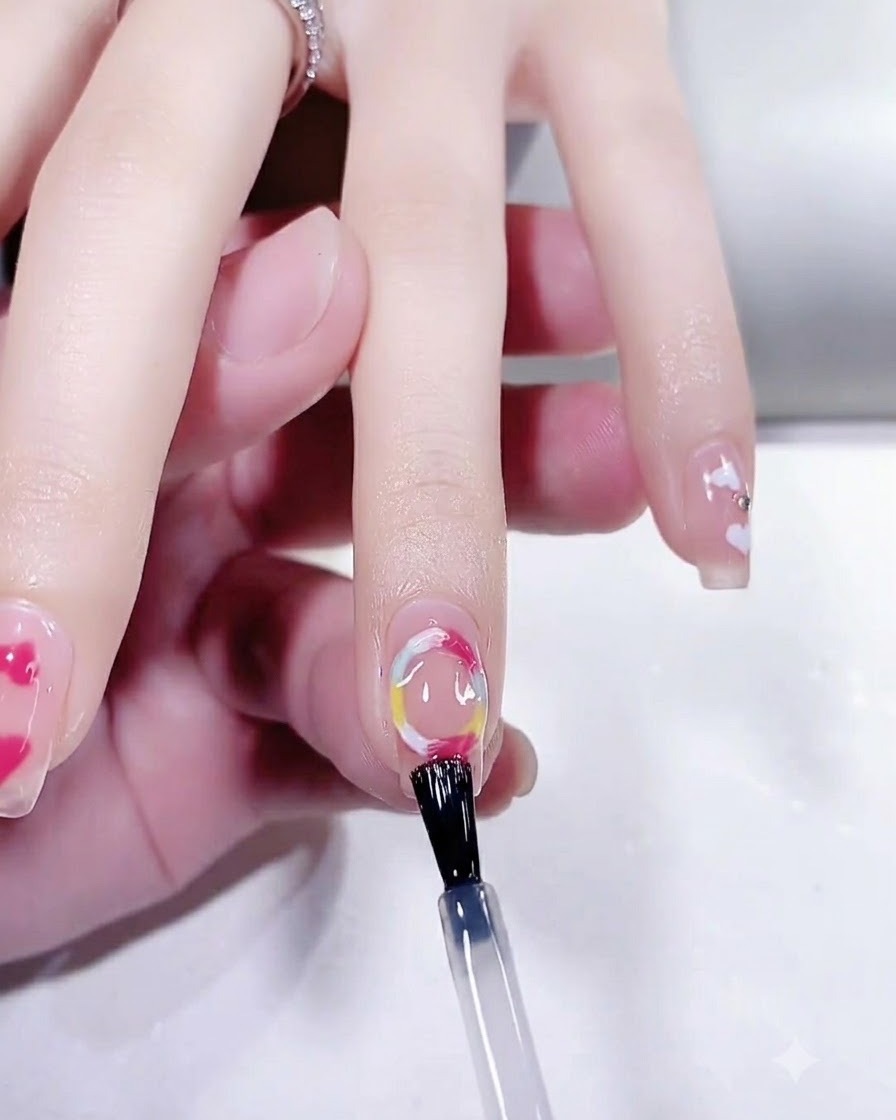 A hand placed inside a UV LED nail lamp curing the final top coat of a manicure.