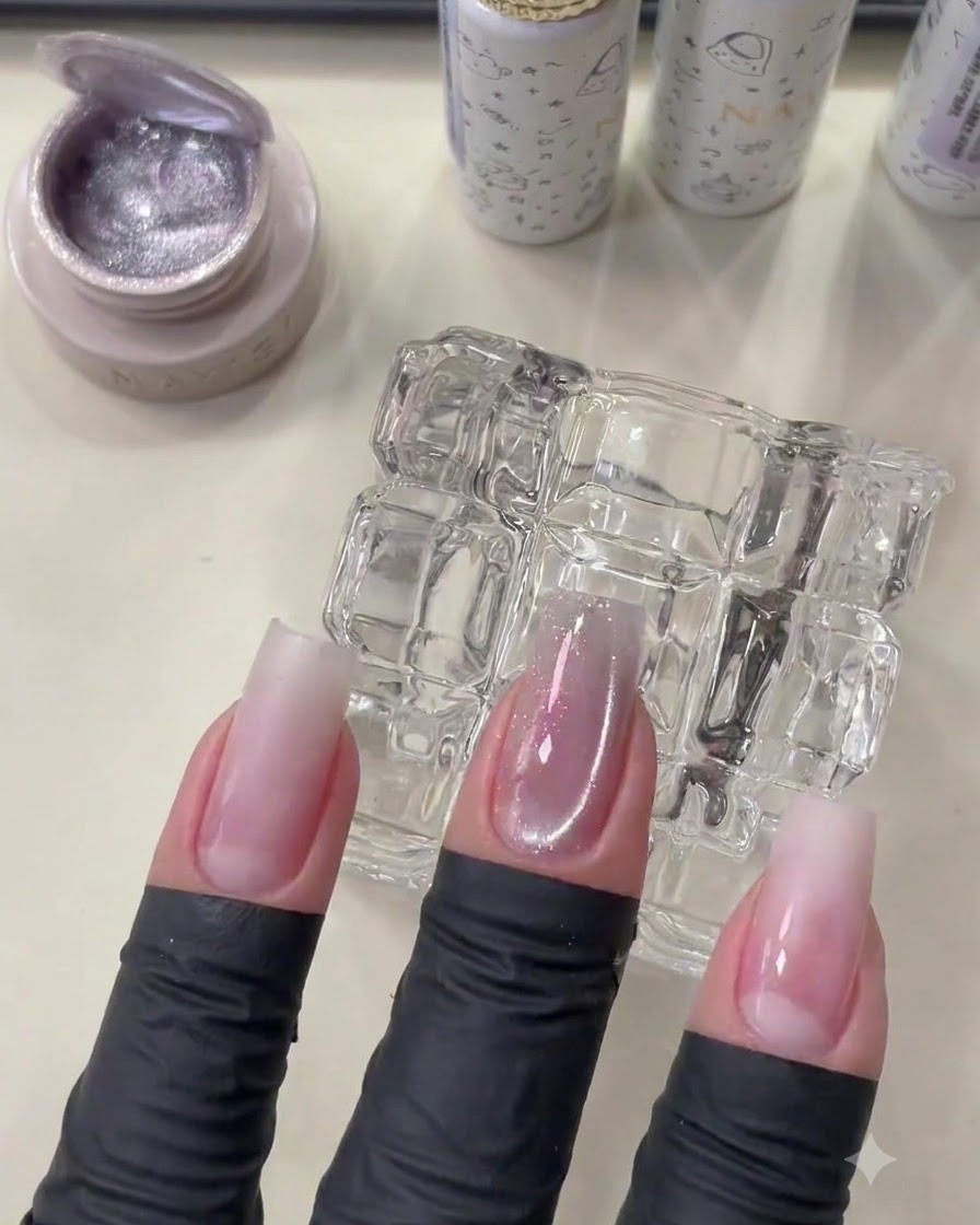 A manicured hand showing the cured cat eye gel with a soft glass bead shimmer.