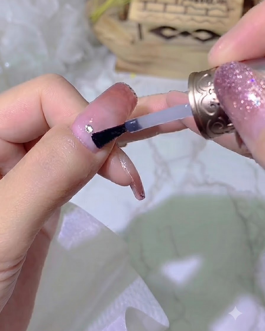 A hand positioned inside a professional UV nail lamp for curing.