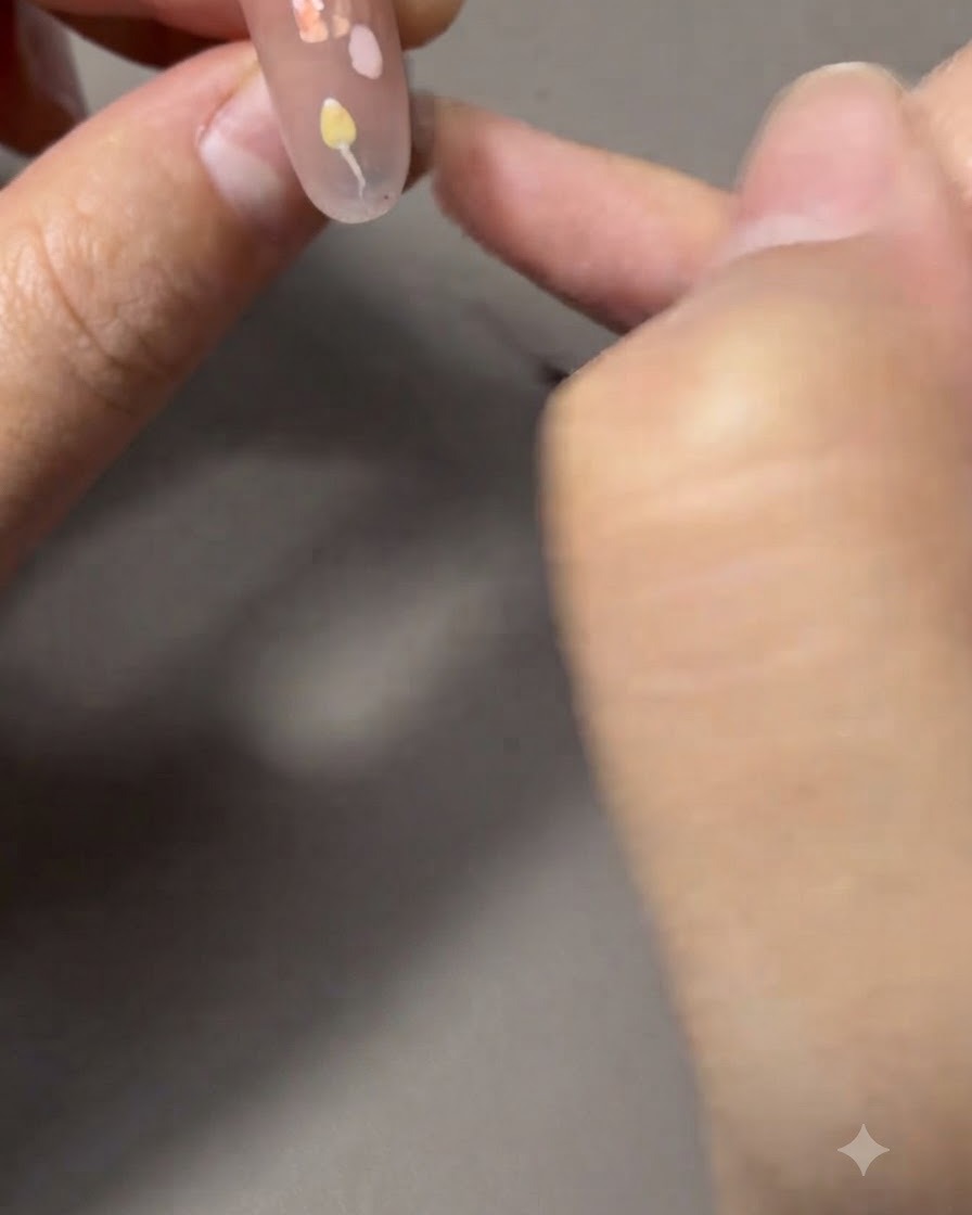 A fine liner brush painting thin green stems and leaves connected to a tulip.
