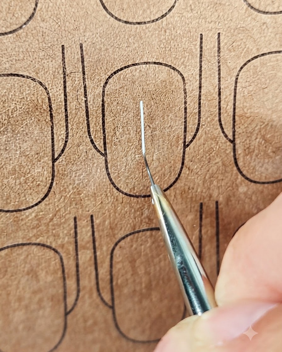 A close-up shot of a liner brush drawing a horizontal white line across a vertical line on a practice nail surface.