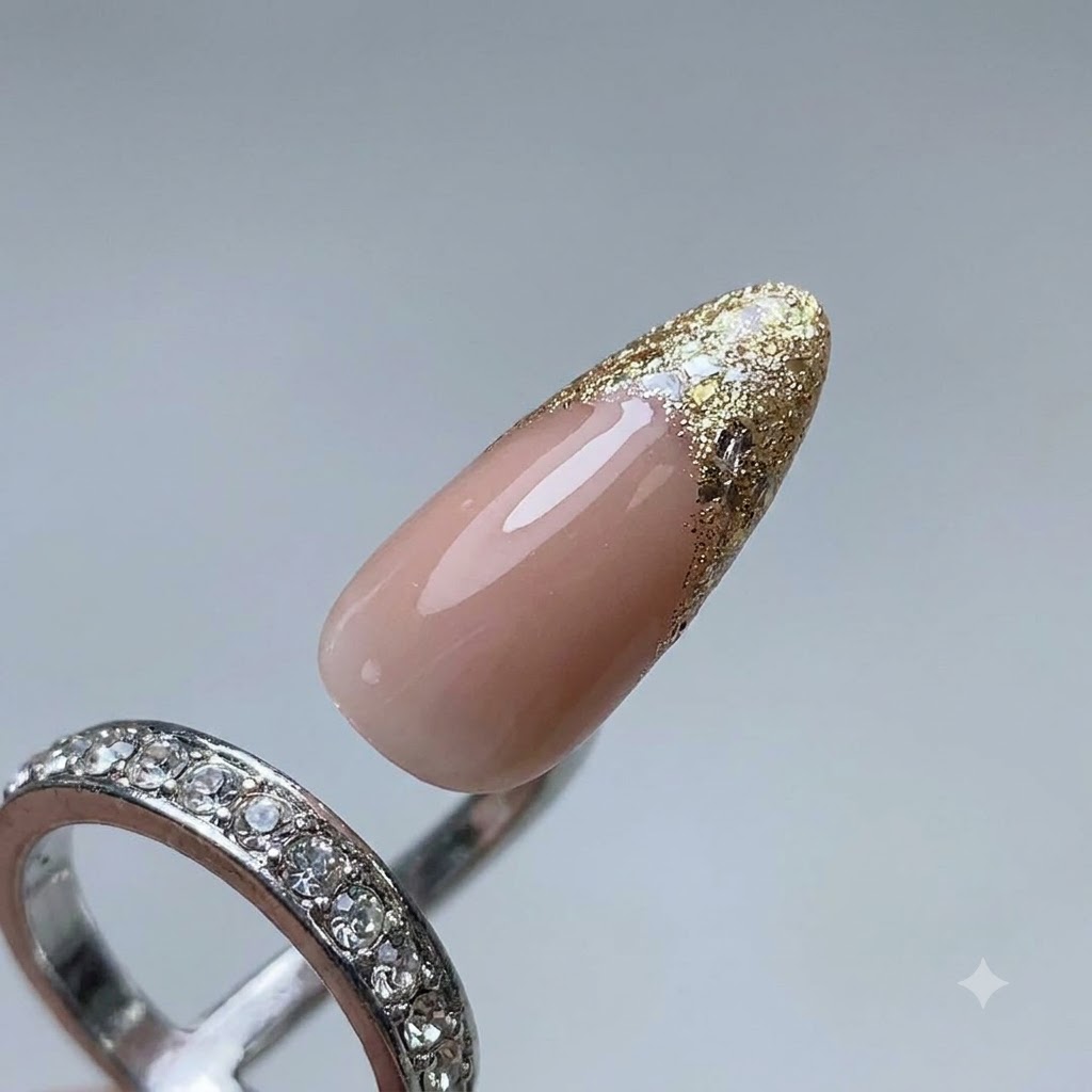 A close-up of a nail brush applying platinum gel to form a French tip guide line on a manicured nail.
