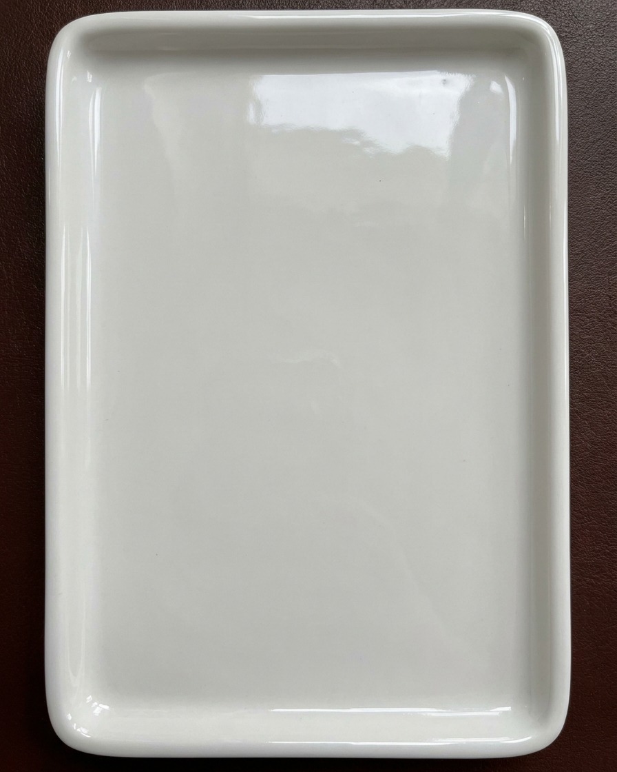 A clean white ceramic mixing palette ready for watercolor nail pigments.