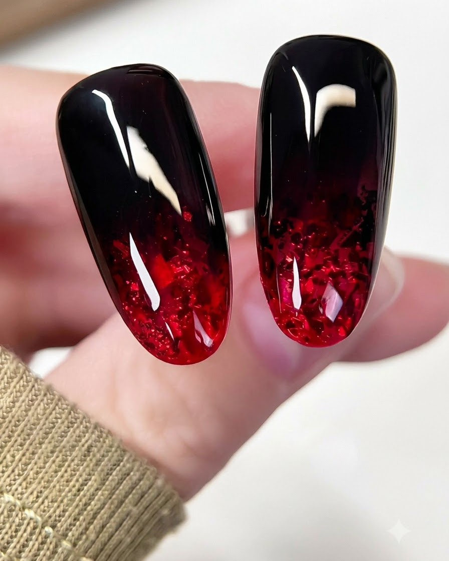 A small nail brush applying black gel to the top portion of an almond nail with a tapping motion.