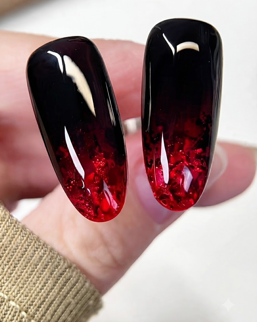 A brush applying a vibrant translucent red gel layer over the glitter portion of the nail.