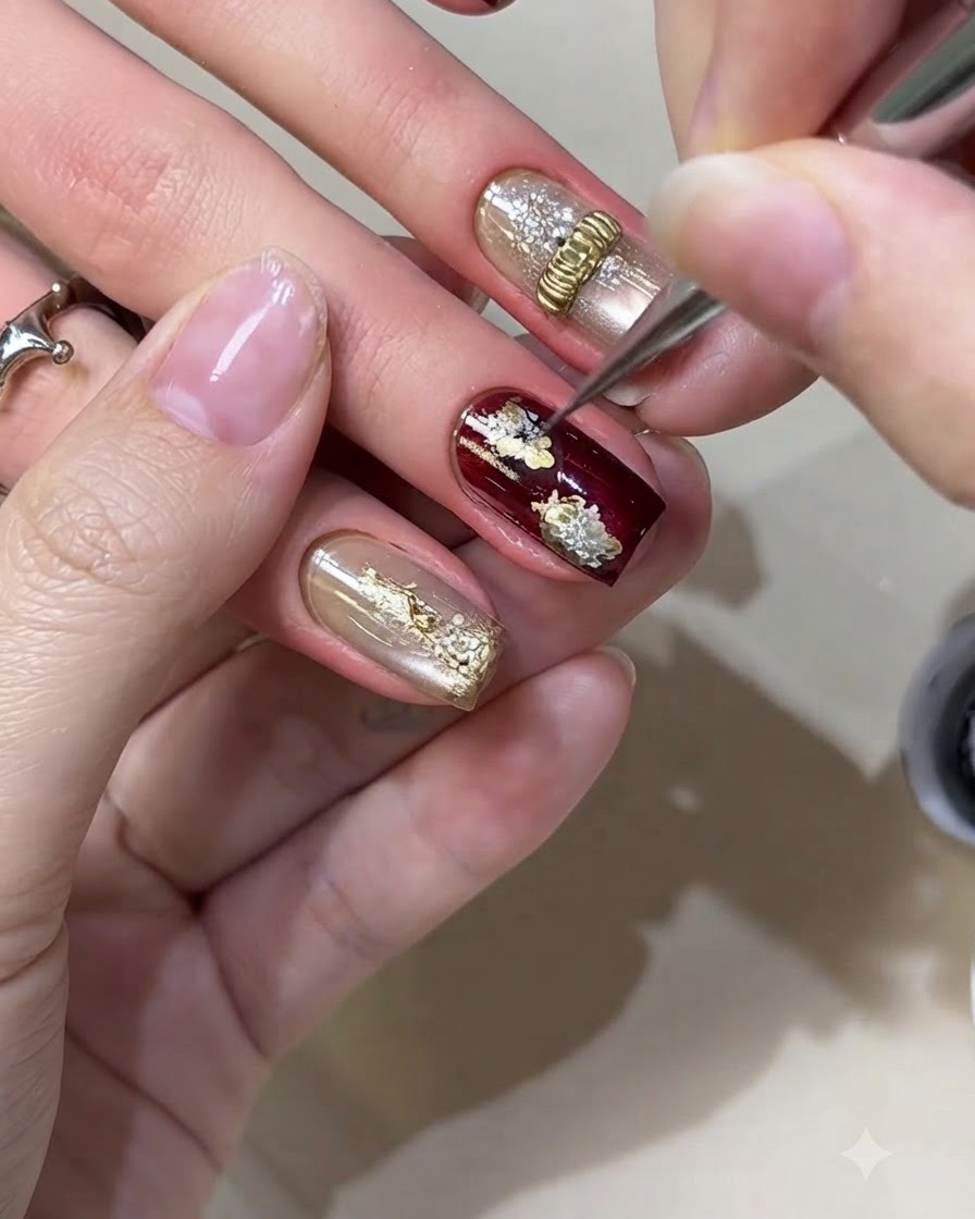 A fine liner brush adding tiny black fine lines to the center of white floral nail art.