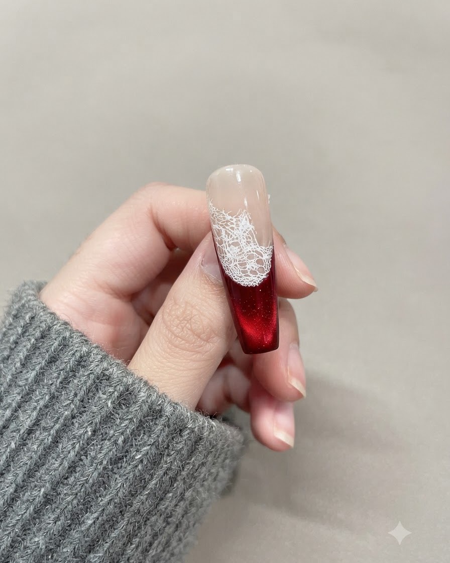 A magnetic wand held near the red cat-eye gel surface to pull the shimmer particles upward.
