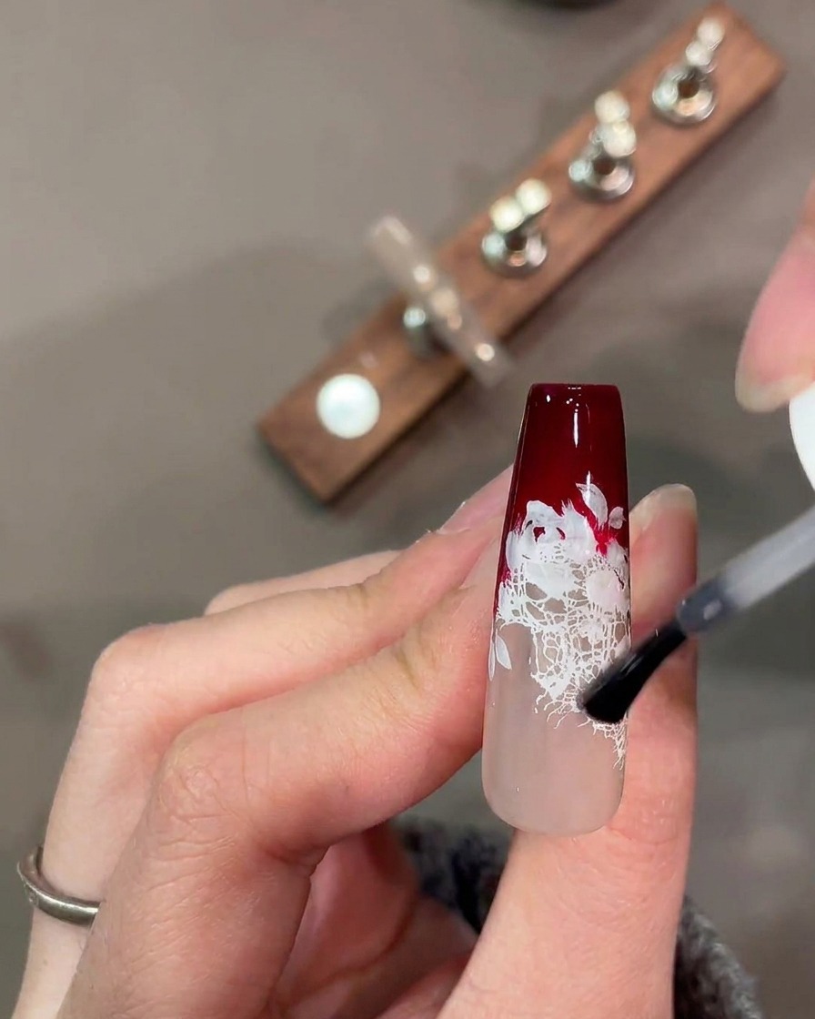 A watercolor palette with mixed red, green, and pink pigments for nail art.