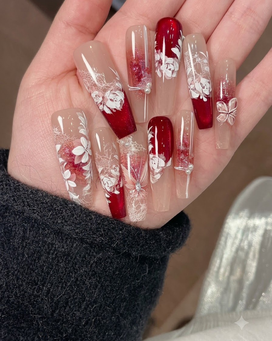 A fine brush painting leaves with a mixed green and red watercolor pigment on a nail design.
