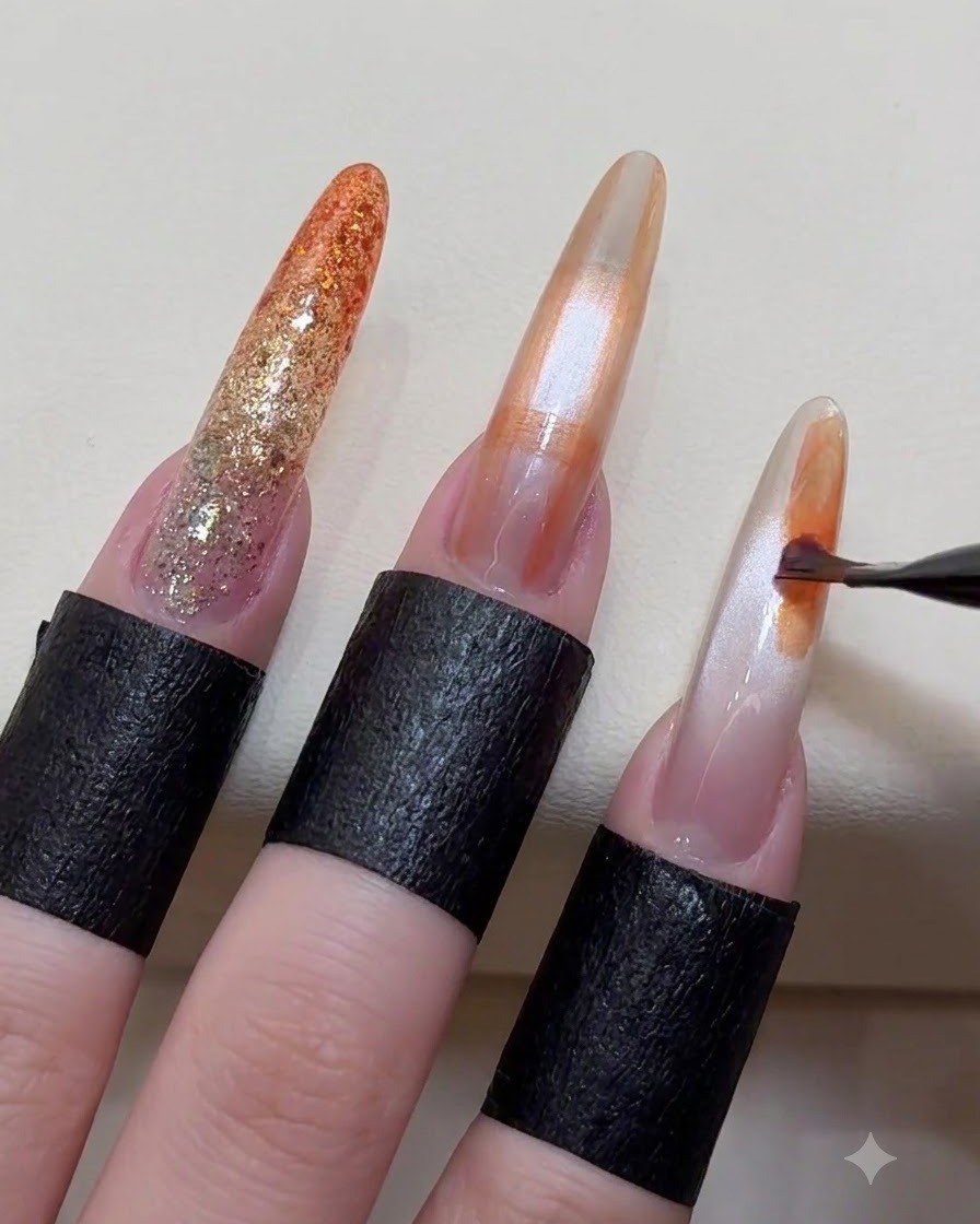A nail art brush applying random abstract color blocks onto the surface of an almond-shaped nail.