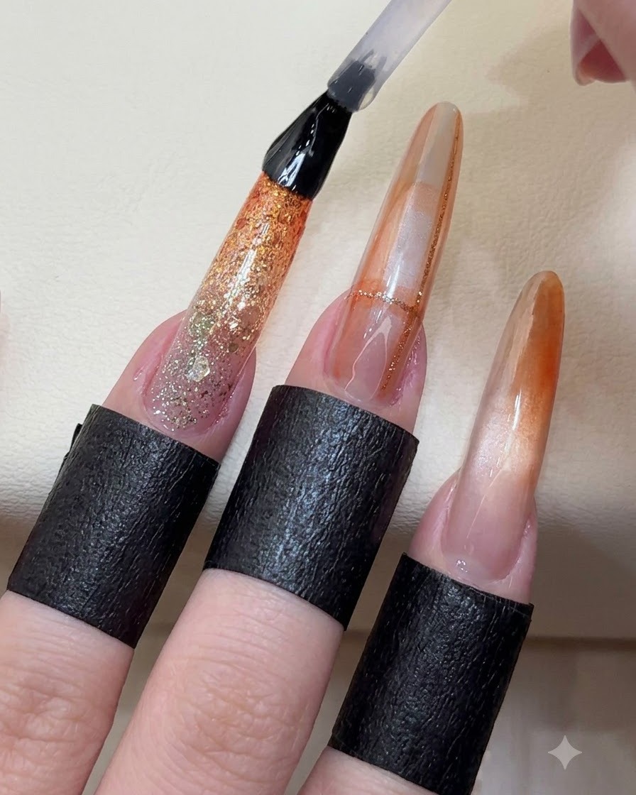 A top coat brush applying a glossy sealant layer over finished nail art extensions.