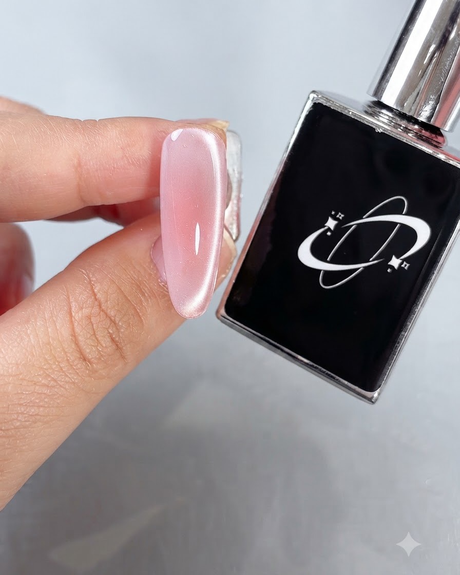 A fingernail with a cured glossy finish held near a black gel polish bottle under studio lighting.