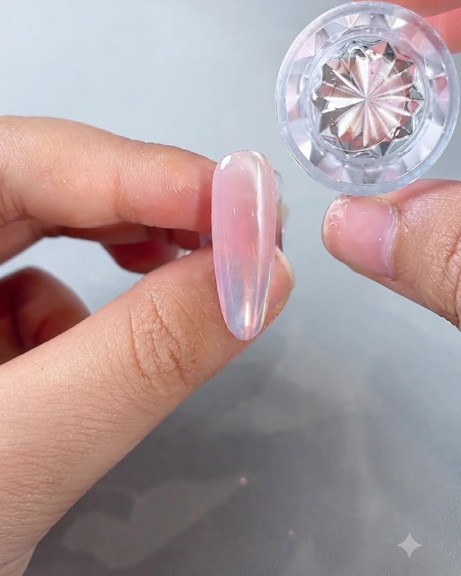 A jar of ice island aurora powder held next to an almond-shaped nail showcasing a clean, advanced finish.