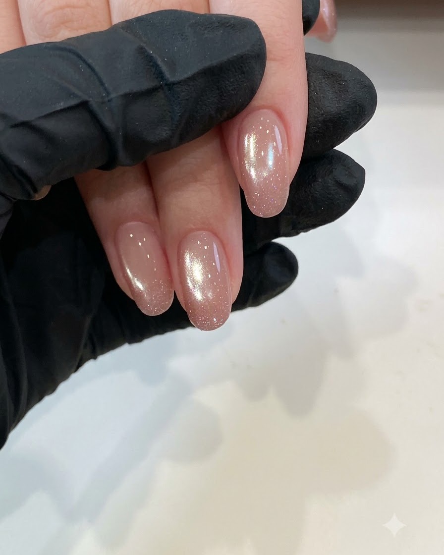 Close-up view of clean short natural nails ready for base coat preparation under studio lighting.