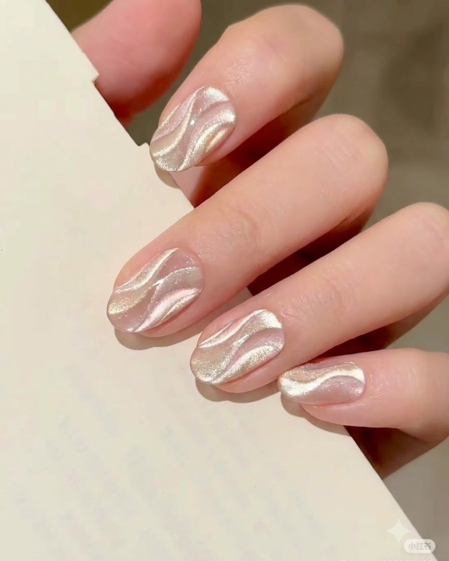 A hand resting inside a professional UV/LED nail lamp, curing the freshly magnetized cat eye nail art.