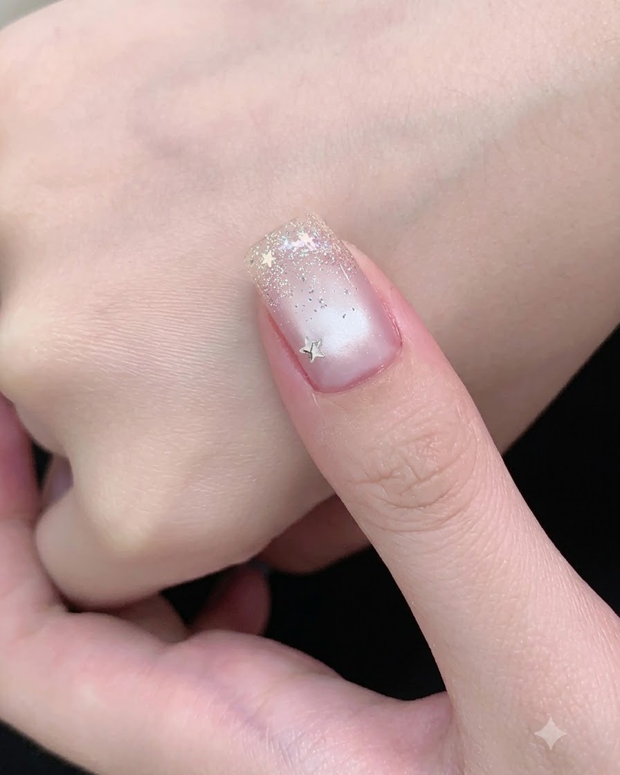 A magnetic wand moving back and forth above a nail coated in wet cat-eye gel.