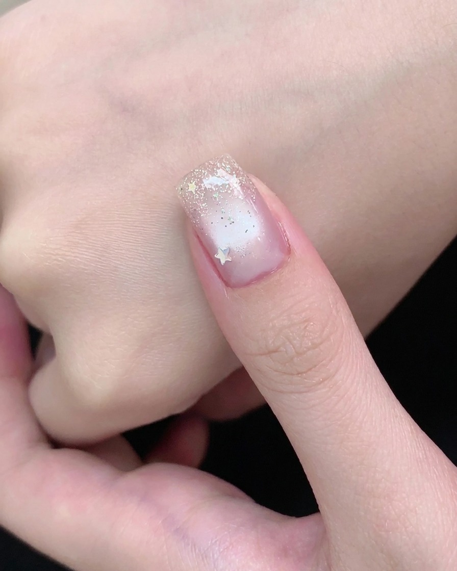 A bar magnet holding a bright shimmer line concentrated down the center of a cat-eye gel nail.