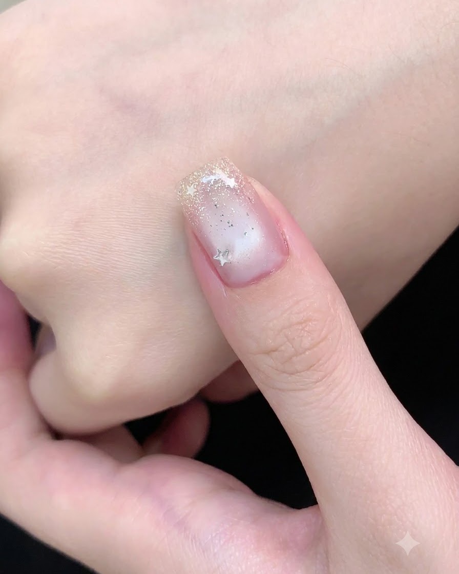 A hand resting inside a pink UV nail lamp curing the cat-eye gel polish.