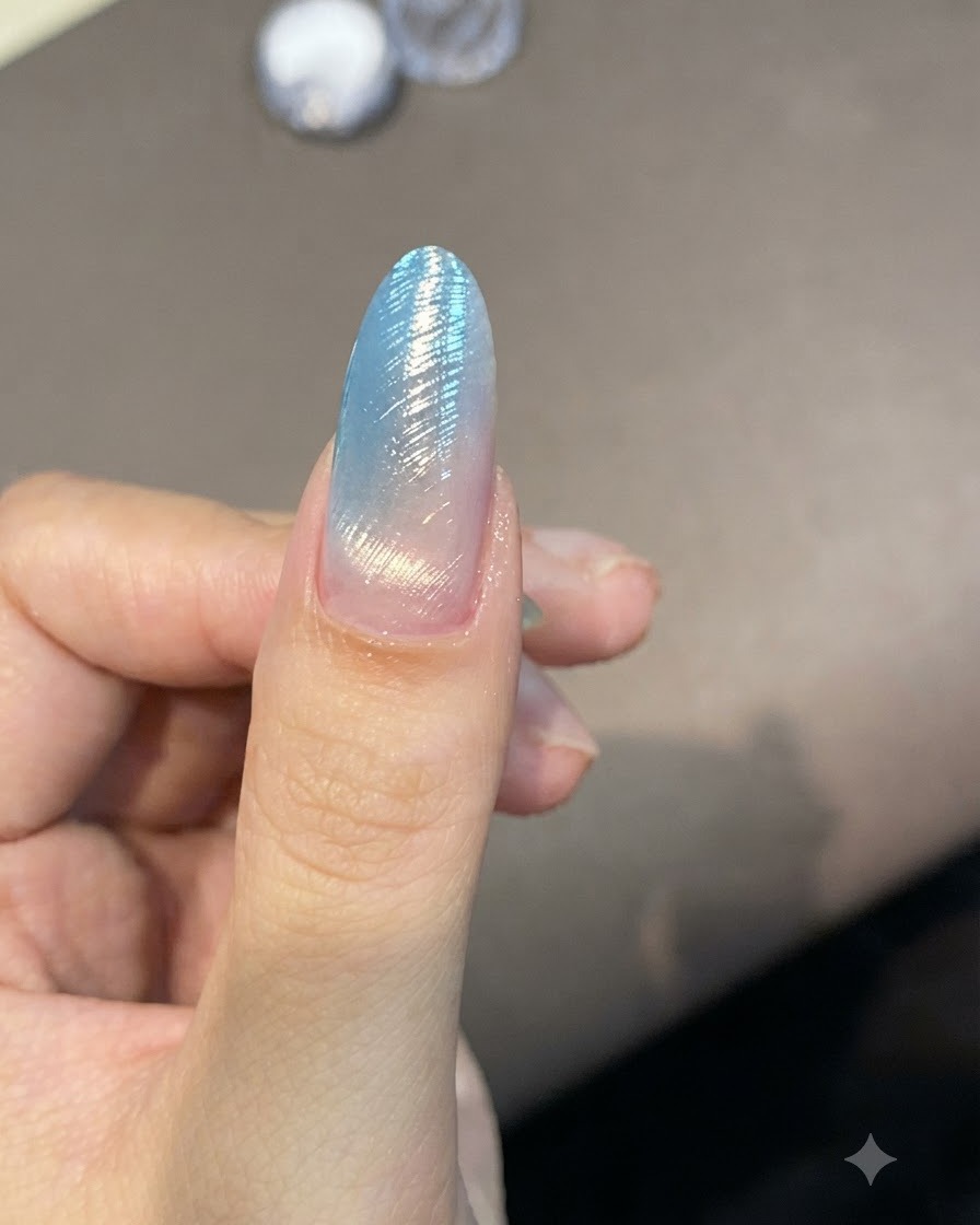 A fine liner brush creating delicate curved lines across a shimmering nail.