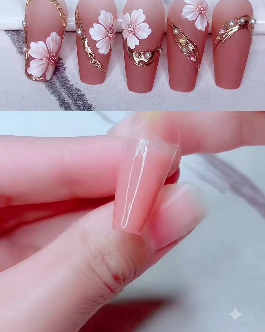 Clear gel adhesive dots applied along a curved gold frame on a decorated nail surface.
