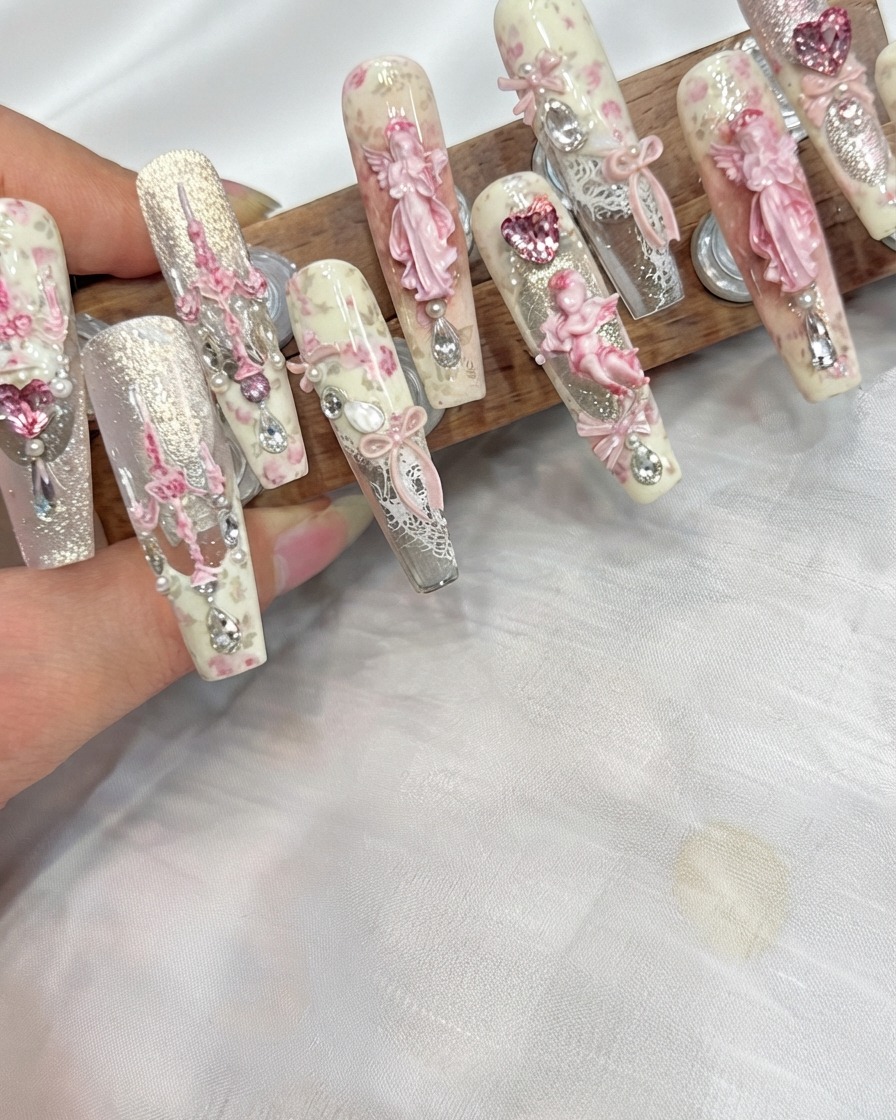 A professional nail brush applying a clear soft base gel onto the natural nail surface.