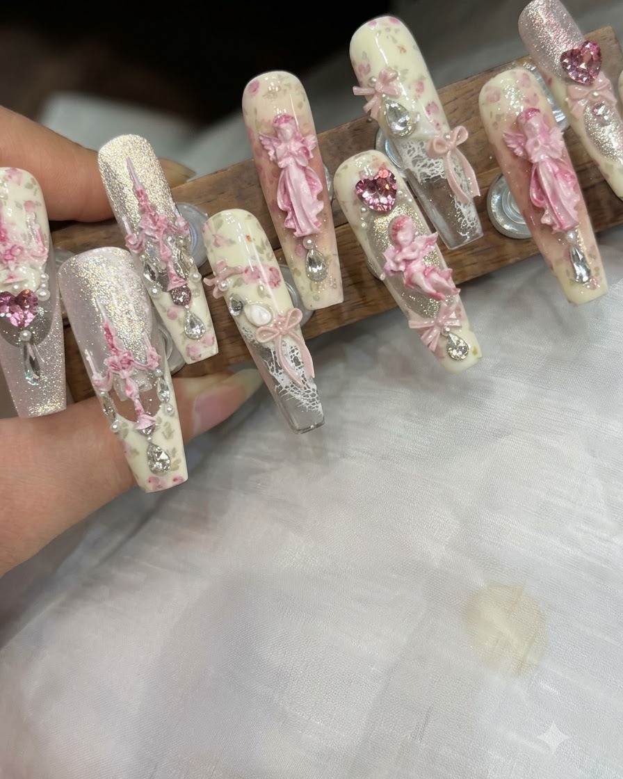 A brush applying a smooth coat of matte top finish over the floral nail art.