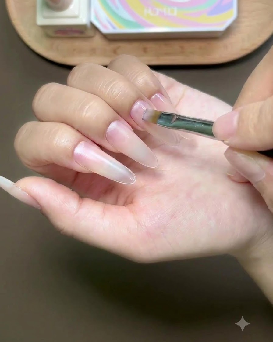 A hand placed inside a curing lamp with the fingers illuminated by UV light.