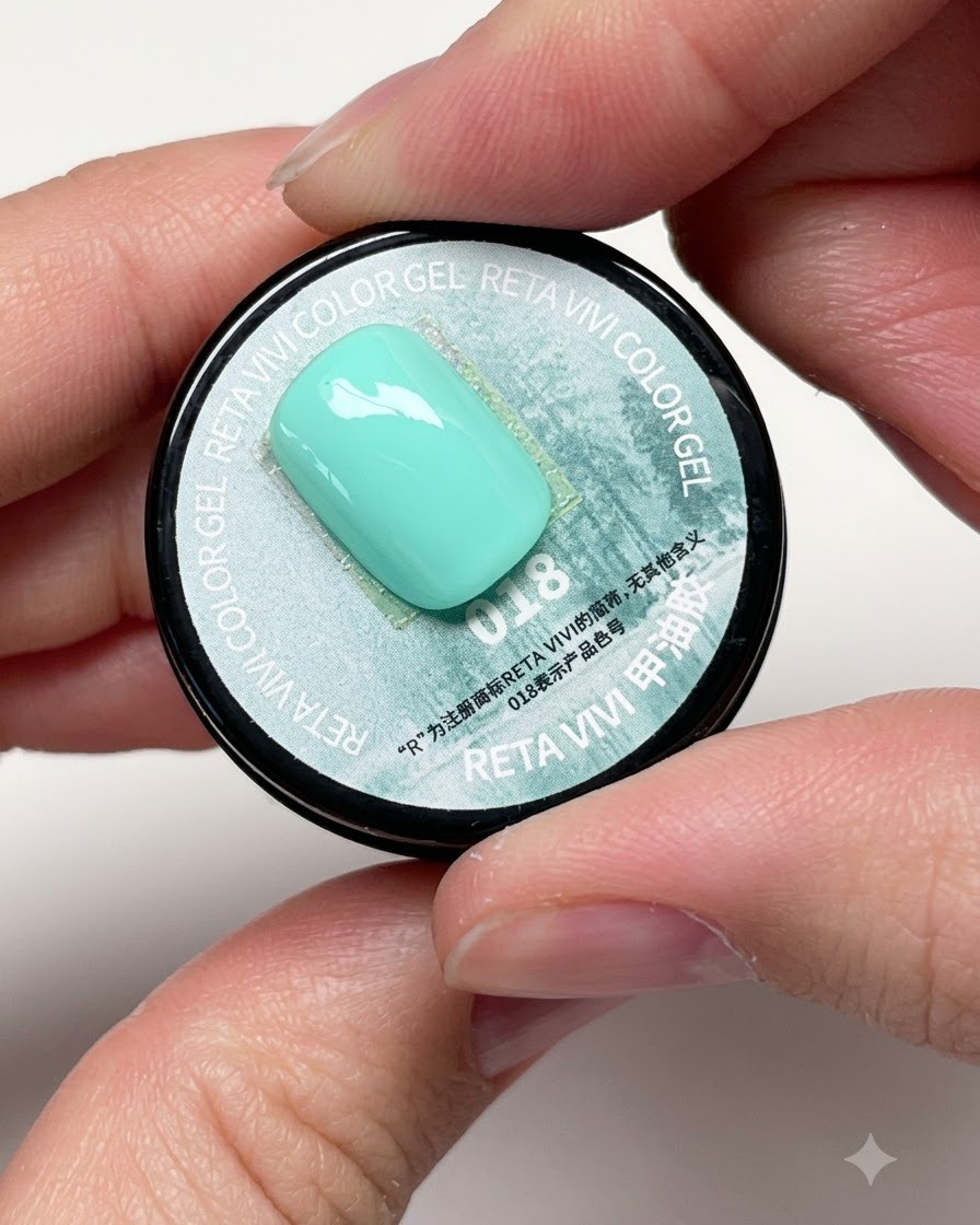 A flat brush dipping into a jar of vibrant mint green color gel labeled with number 018.