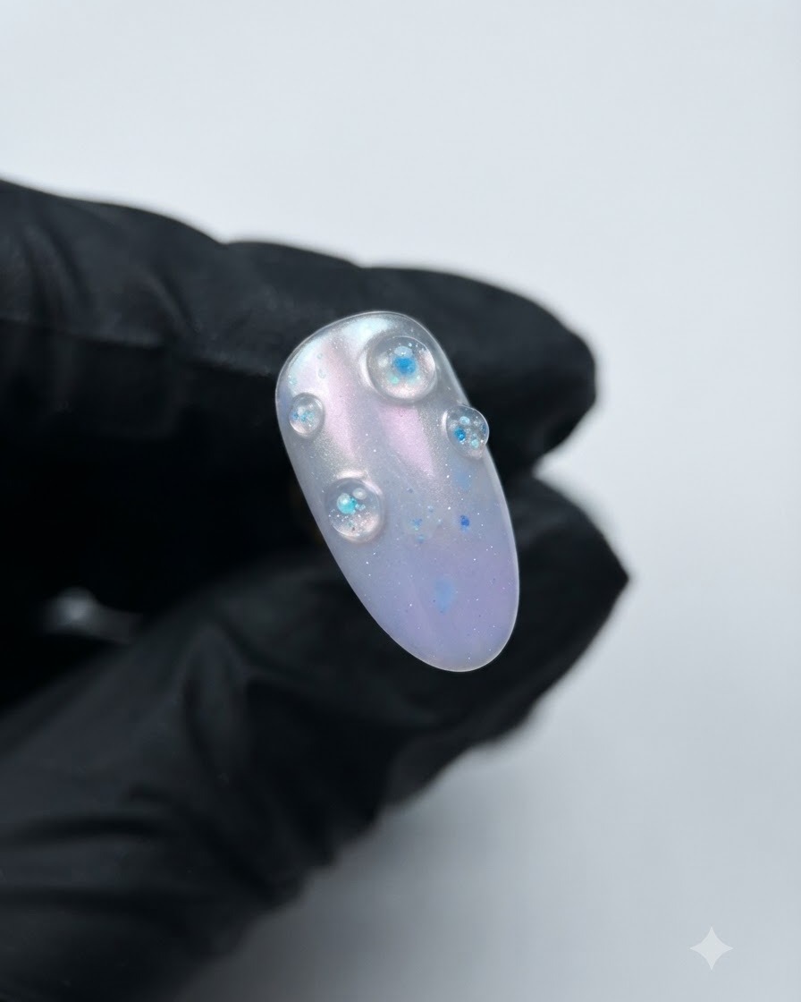 A completed nail featuring raised 3D purple crystal structural gel bubbles over an aurora base.