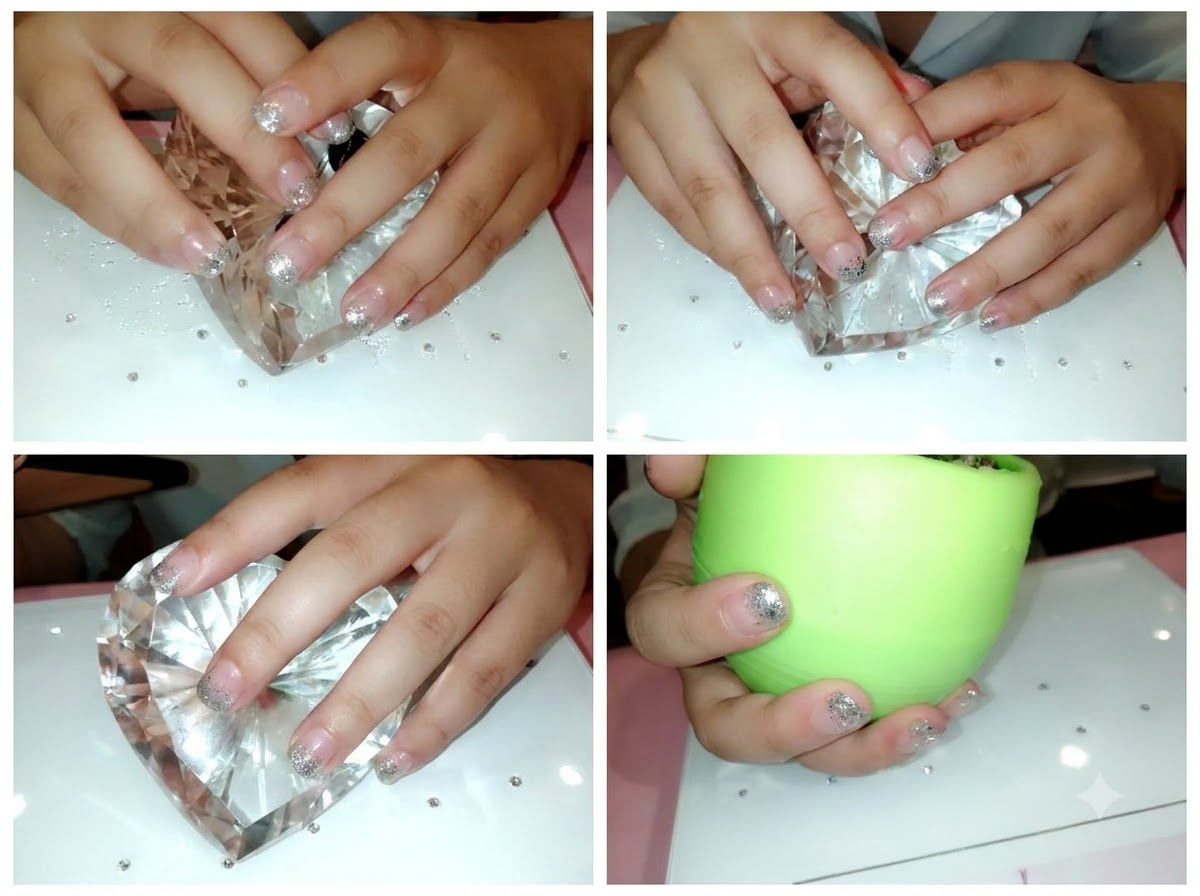 A close-up view of hands with prepped natural nails resting on a crystal heart display.