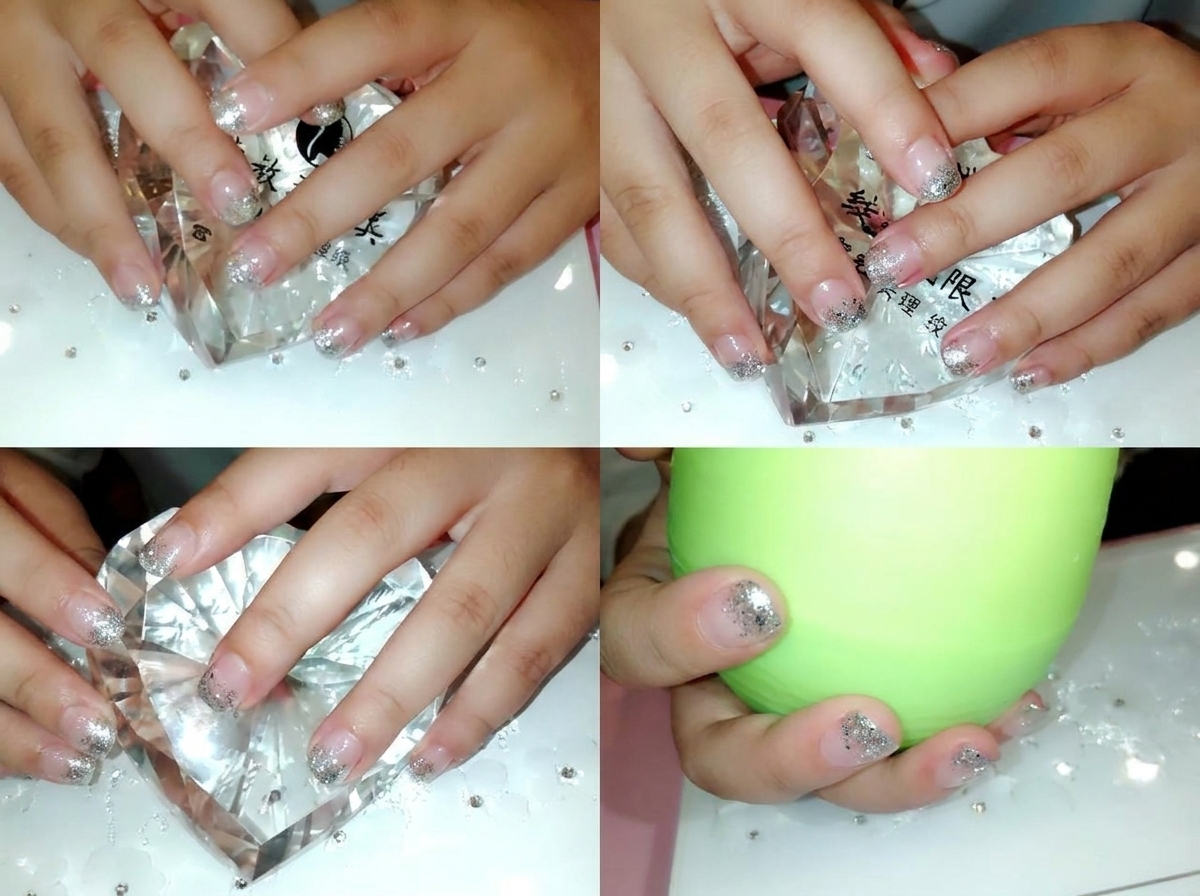 Using precision tweezers to place small clear crystals near the cuticle line.